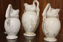 A SET OF THREE GRADUATING ANTIQUE SWAN JUGS
