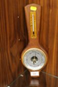 A SMALL WALL MOUNTED BAROMETER