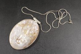 A SILVER MOUNTED MOTHER OF PEARL PENDANT DECORATED WITH A KOI CARP