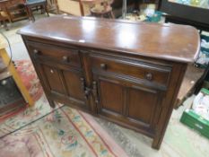 AN ERCOL STYLE DARK OAK SIDEBOARD