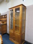 A DUCAL PINE GLAZED DISPLAY CABINET H- 188 CM W-93 CM