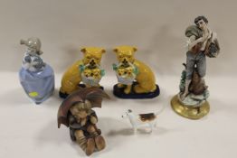 A GOEBEL BOY SITTING UNDER AN UMBRELLA TOGETHER WITH A PAIR OF STAFFORDSHIRE STYLE PUG DOGS ETC