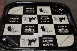 A VINTAGE BLACK AND WHITE WHISKY DRINKS TRAY