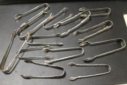 A COLLECTION OF 13 SILVER TONGS, ICE TONGS ETC