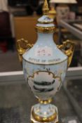 A LIMITED EDITION LIDDED TWIN HANDLED RAF COMMEMORATIVE GILT FINISH VASE BY MALCOLM BARNETT NUMBER
