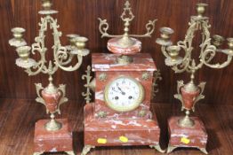 A FRENCH STYLE RED MARBLE AND GILT METAL CANDELABRA CLOCK GARNITURE