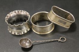 TWO HALLMARKED SILVER NAPKIN RINGS TOGETHER WITH A PLATED EXAMPLE AND A SPOON (4)