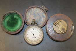 AN ANTIQUE GENUINE POCKET BAROMETER BY LAWRENCE AND MAYO LTD OF LONDON TOGETHER WITH A MANUALLY WIND