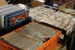 A LARGE QUANTITY OF 7 INCH SINGLE RECORDS TOGETHER WITH A TRAY OF ASSORTED LASER DISCS