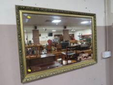 A MODERN GILT FRAMED WALL MIRROR 66 X 96 CM