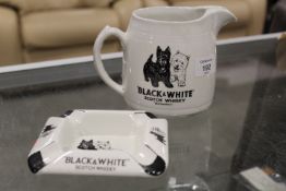 A VINTAGE BLACK AND WHITE WHISKY JUG AND MATCHING ASHTRAY