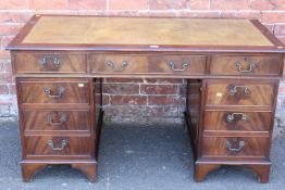 A REPRODUCTION MAHOGANY LEATHER TOPPED TWIN PEDESTAL DESK - W 137 CM