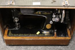 A VINTAGE CASED SINGER SEWING MACHINE MODEL NUMBER EA843385