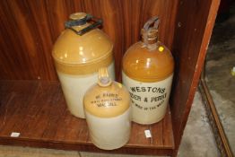 TWO LARGE STONE WARE ADVERTISING FLAGON'S TOGETHER WITH A LARGER SWING HANDLED FLAGON (3)