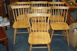 A SET OF SEVEN MODERN LIGHT OAK DINING CHAIRS