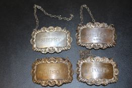 FOUR HALLMARKED SILVER WINE LABLES