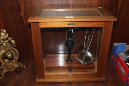 A SET OF SCIENTIFIC SCALES IN GLAZED CABINET
