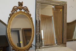 A MODERN RECTANGULAR MIRROR AND AN OVAL MIRROR (2)