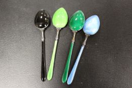 A FITTED BOX OF FOUR STERLING SILVER ENAMEL TEA SPOONS