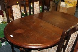 AN OAK EFFECT EXTENDING DINING TABLE AND FOUR CHAIRS