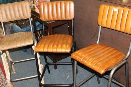 A HARLEQUIN SET OF THREE LEATHER BAR / KITCHEN STOOLS
