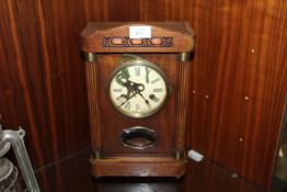 A VINTAGE OAK CASED MANTEL CLOCK
