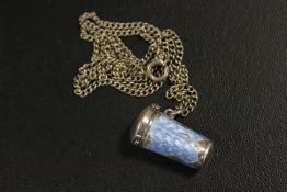 AN ANTIQUE SILVER AND ENAMEL PILL BOX ON SILVER CHAIN