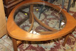 A RETRO TEAK AND GLASS TOPPED COFFEE TABLE