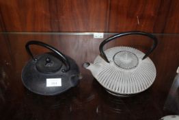 TWO MODERN SHALLOW CAST METAL TEA POTS