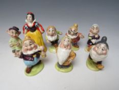 A SET OF BESWICK SNOW WHITE & THE SEVEN DWARFS CERAMIC FIGURES, all with gold backstamps