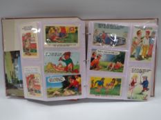AN ALBUM CONTAINING APPROXIMATELY 180 GOLF RELATED POSTCARDS, to include saucy seaside humour