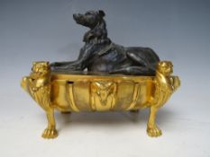 A 19TH CENTURY ORMOLU INKSTAND, the oval vessel raised on four paw feet, with three openings to