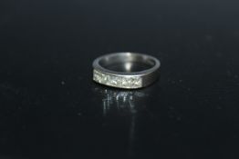 A HALLMARKED 18 CARAT GOLD CHANNEL SET PRINCESS CUT DIAMOND RING, set with five diamonds, approx