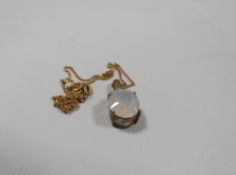 A HALLMARKED 9CT GOLD MOONSTONE TYPE PENDANT, the faceted opaque glass stone with three clear