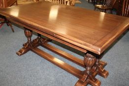 A JAYCEE OAK DRAWLEAF DINING TABLE, having an unusual twin baluster carved column structure,