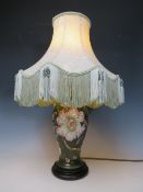 A LARGE MOORCROFT FLORAL PATTERN TABLE LAMP, dark green ground to lamp base, with shade, H 30 cm (