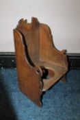 A SMALL ANTIQUE OAK CHILDS 'LAMBING' CHAIR, with a hole for commode