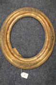 A 19TH CENTURY DECORATIVE OVAL GOLD FRAME, frame W 7.5 cm, site size 30 x 24 cm, rebate 31.5 x 28