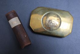 A BRASS LIDDED TOBACCO BOX WITH KOLN CATHEDRAL TOP, together with a leather stamp box in the form of