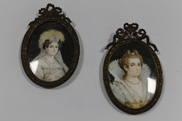 A PAIR OF 19TH CENTURY OVAL PORTRAIT MINIATURES OF ELEGANT YOUNG LADIES, unsigned, framed and