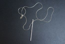 A HALLMARKED 18 CARAT GOLD DIAMOND SET DROPPER PENDANT, on a hallmarked 18 carat white gold snake