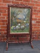 A 19TH CENTURY CARVED OAK FIRESCREEN WITH INSET WATERCOLOUR, carved with trailing vine leaves and
