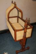 AN ANTIQUE BERGERE ROCKING CRADLE, H 123 cm, L 102 cm
