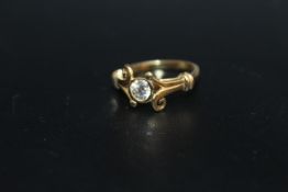 A HALLMARKED 18 CARAT GOLD HALF CARAT DIAMOND RING, in an unusual split swirl band setting, the
