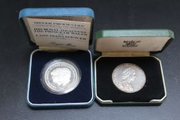 A SILVER NATIONAL TRUST MEDAL, together with a Royal Wedding silver proof coin, both cased (2)