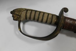 A 19TH CENTURY NAVAL CEREMONIAL SWORD IN LEATHER SCABBARD, the blade with engraved detail, L 96 cm