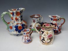 A COLLECTION OF FOUR ASSORTED MASONS IRONSTONE JUGS, together with a modern equivalent, largest H 19