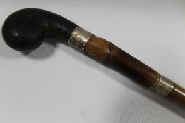 AN ANTIQUE SILVER BANDED SWORD STICK, with ebonised pommel, L 96 cm