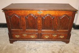 AN 18TH CENTURY OAK MULE CHEST, the hinged lid above a fielded four panel front, two drawers