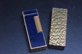 A BLUE ENAMEL AND GOLD PLATED DUNHILL LIGHTER, together with another, H 6.5 cm (2)